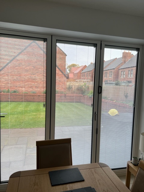 Another view of bifolding doors with blinds